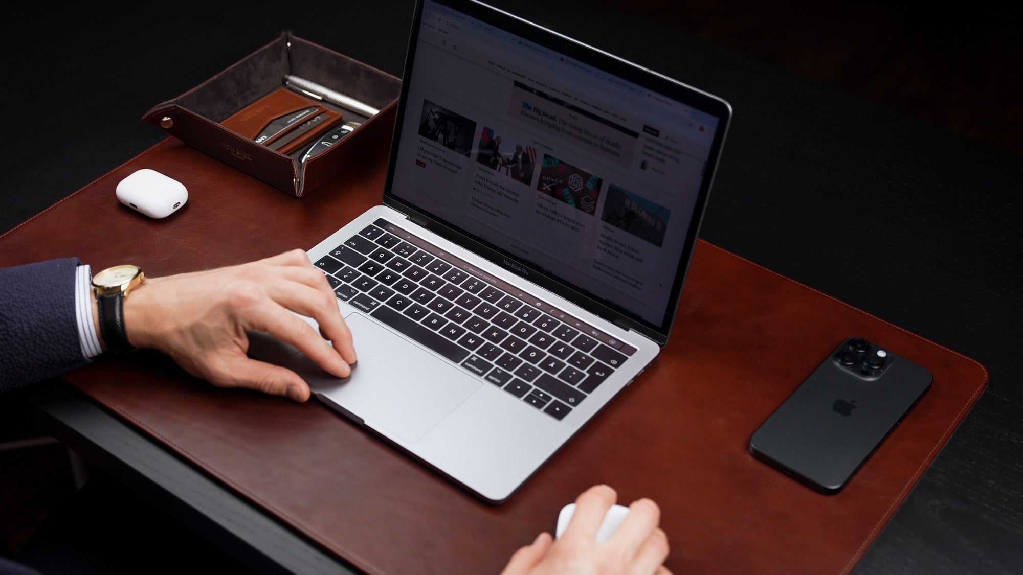 Von Baer Executive large brown leather desk pad and laptop mat used by man in suit working on MacBook 16x9