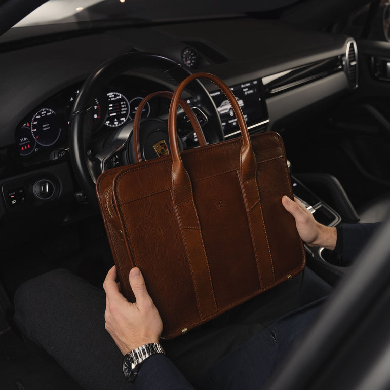 Von Baer Exquisite high-quality luxury slim full-grain leather laptop bag in Porsche held by businessman