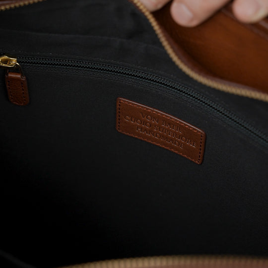 Von Baer Exquisite luxury full-grain leather men's laptop briefcase in brown, featuring an internal zipped pocket.