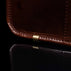 Men’s Von Baer Exquisite luxury full-grain leather laptop briefcase in brown, featuring protective metal feet close-up.