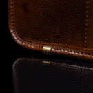 Von Baer Exquisite luxury full-grain leather laptop briefcase for women in brown, featuring protective metal feet, close-up view.