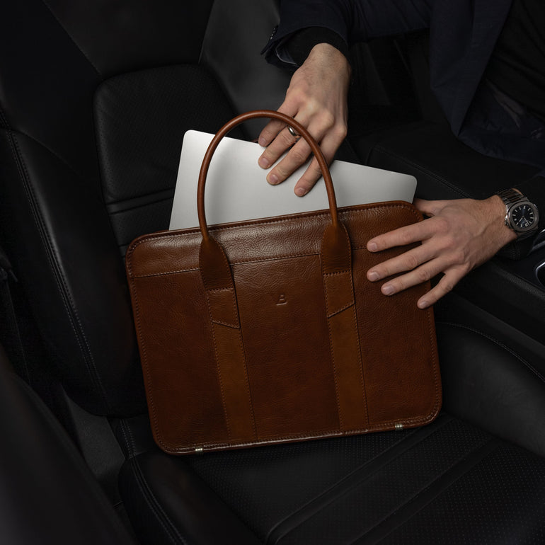 Von Baer Exquisite luxury slim full-grain leather laptop bag with businessman taking out MacBook in Porsche car