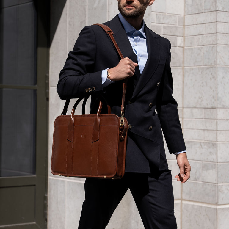 An exquisite, slim, brown Von Baer full-grain leather laptop briefcase with a shoulder strap