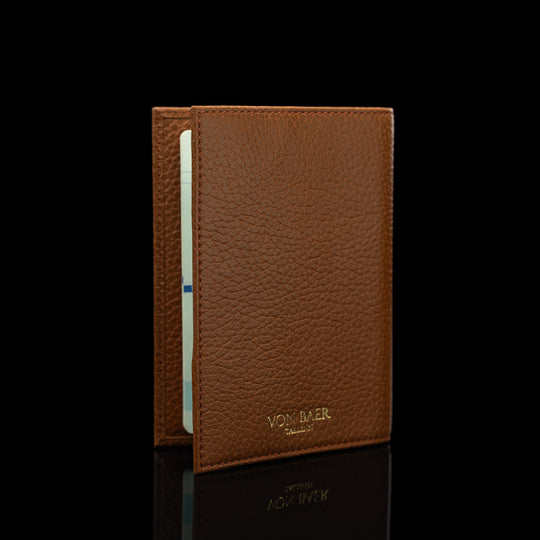 Von Baer full grain leather passport cover holder, half-turned view on a black background