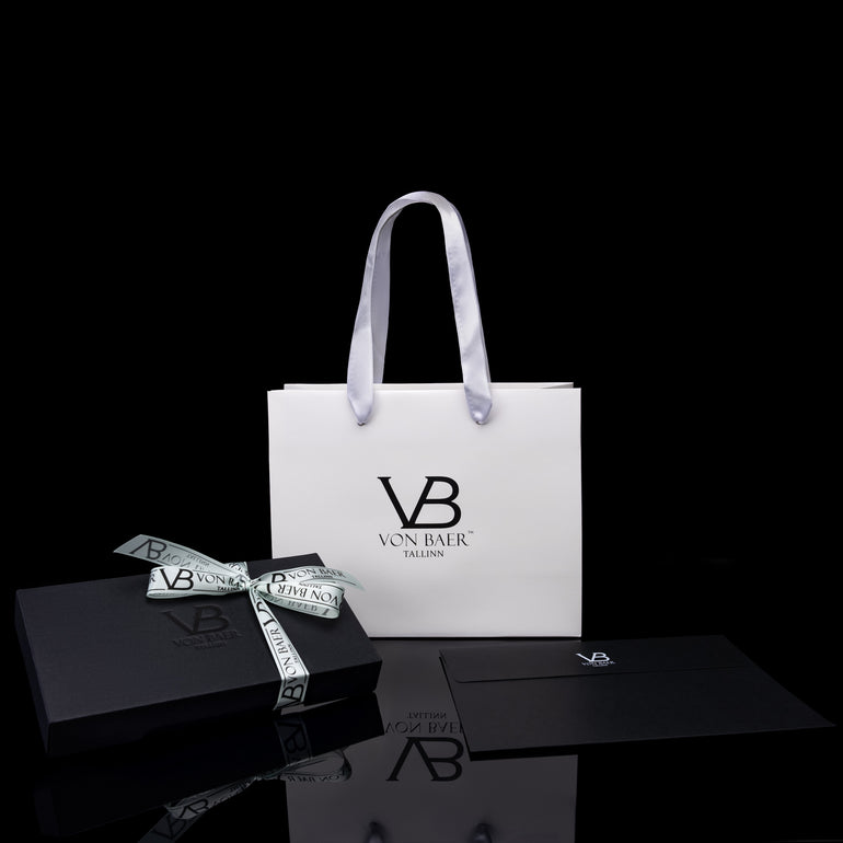 Von Baer luxury gift packaging displayed alongside Allure large leather accordion wallets, a travel organizer, and a leather luggage tag.