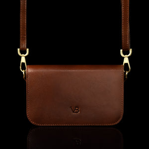 Von Baer Isabella small leather shoulder bag with adjustable strap in brown, front view.