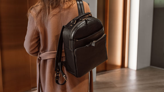 Von Baer Liberty stylish women's full-grain leather backpack black on a beautiful woman in a beige coat