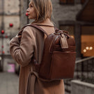 Von Baer Liberty stylish women's full-grain leather backpack brown on a beautiful woman in a beige coat