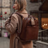 Von Baer Liberty stylish women's full-grain leather backpack brown on a beautiful woman in a beige coat