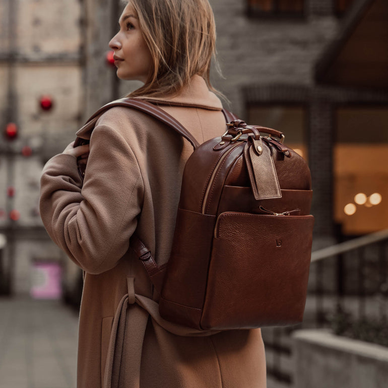 Von Baer Liberty stylish women's full-grain leather backpack brown on a beautiful woman in a beige coat