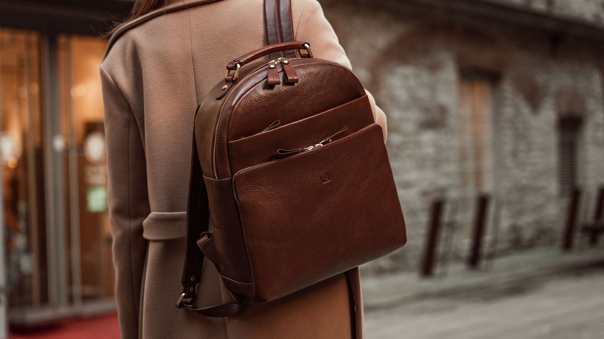 Von Baer Liberty stylish women's full-grain leather backpack brown on a woman in a beige coat