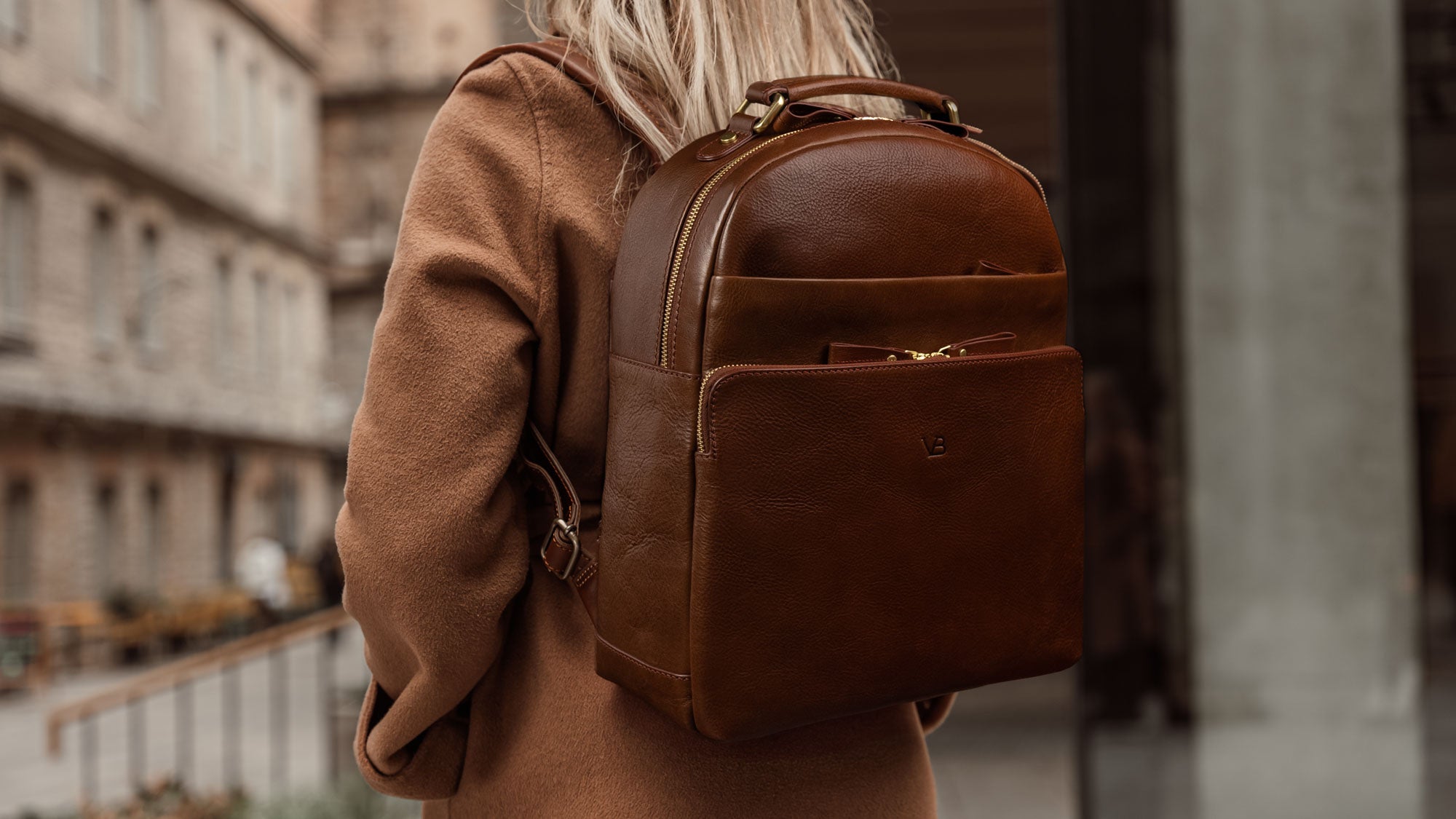 Von Baer Liberty women's stylish Italian leather backpack in brown, worn by a female model on the street, highlighting a fashionable and functional lifestyle.