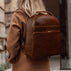 Von Baer Liberty women's stylish Italian leather backpack in brown, worn on the street, showcasing a chic and modern look.