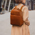 Von Baer Liberty women's stylish Italian leather backpack in tan, worn by a female model, highlighting its elegant and fashionable design.