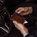 von baer luxury grant leather card case wallet solid brown in the hands of businessman