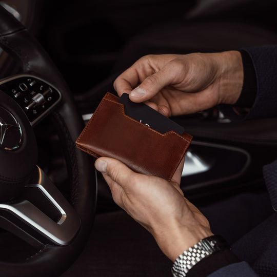 von baer luxury grant leather card case wallet solid brown in the hands of businessman