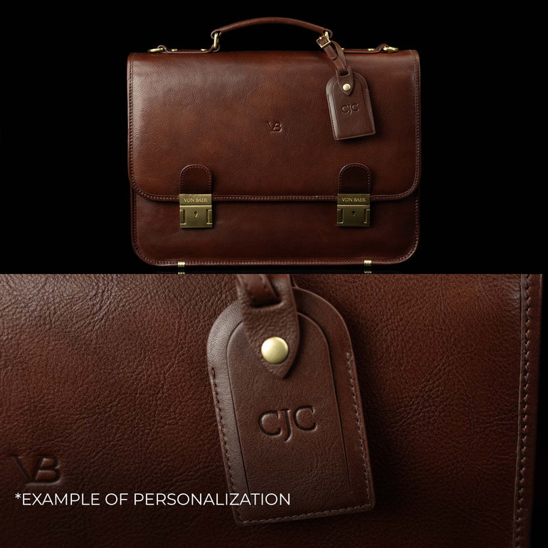 A Von Baer No. 2 leather laptop bag and briefcase, showing an example of personalization with embossed initials on the attached luggage tag.