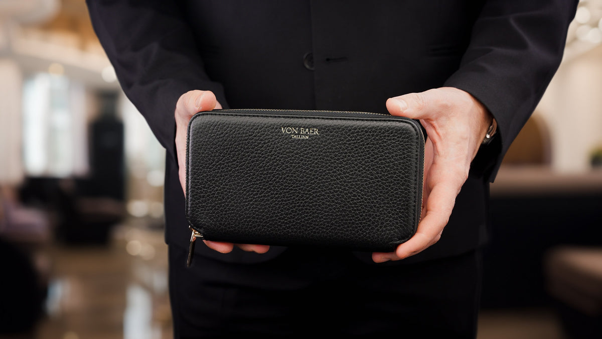 Von Baer origin luxury RFID men’s leather wallet in black held by a male model, premium wallet for professionals.