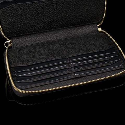 Luxury men’s leather wallet with RFID protection, large design with card slots filled with cards, bottom section visible.