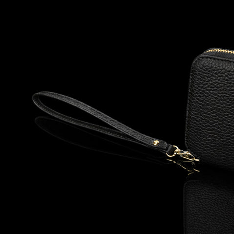 Von Baer origin luxury RFID men’s leather wallet in cognac tan with wrist strap, close-up showing premium detail.