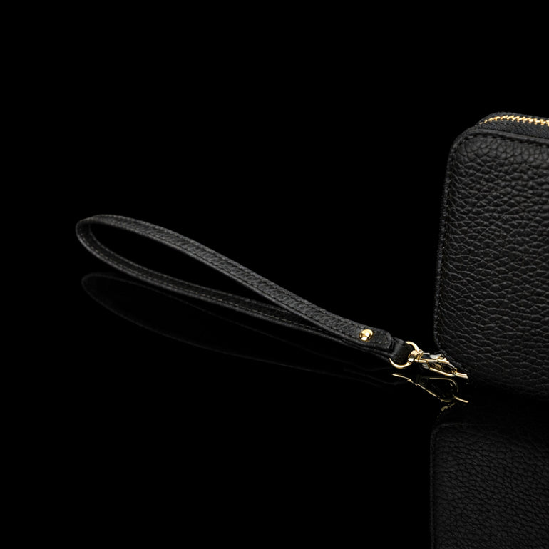 Von Baer origin luxury RFID men’s leather wallet in cognac tan with wrist strap, close-up showing premium detail.