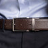 Von Baer Premier full-grain reversible brown leather 2-in-1 belt with silver buckle, worn by a man over a light blue shirt and dark pants