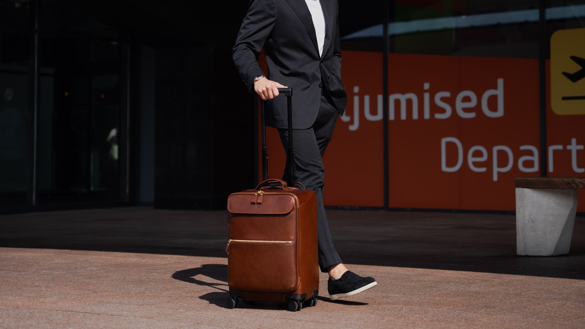 Von Baer Voyager luxury carry on trolley bag in an airport near the departures terminal
