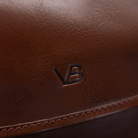 Close-up of the VB logo on the brown Von Baer Voyager women's luxury leather carry on trolley bag