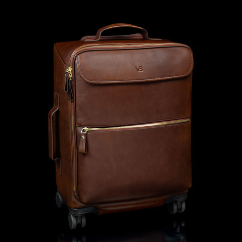 Brown Von Baer Voyager women's luxury leather carry on trolley bag for travel on black background