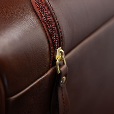Close-up of the zipped pocket for the handle on the brown Von Baer Voyager women's luxury leather carry on bag