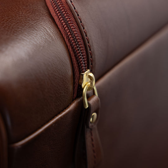 Close-up of the zipped pocket for the handle on the brown Von Baer Voyager women's luxury leather carry on bag