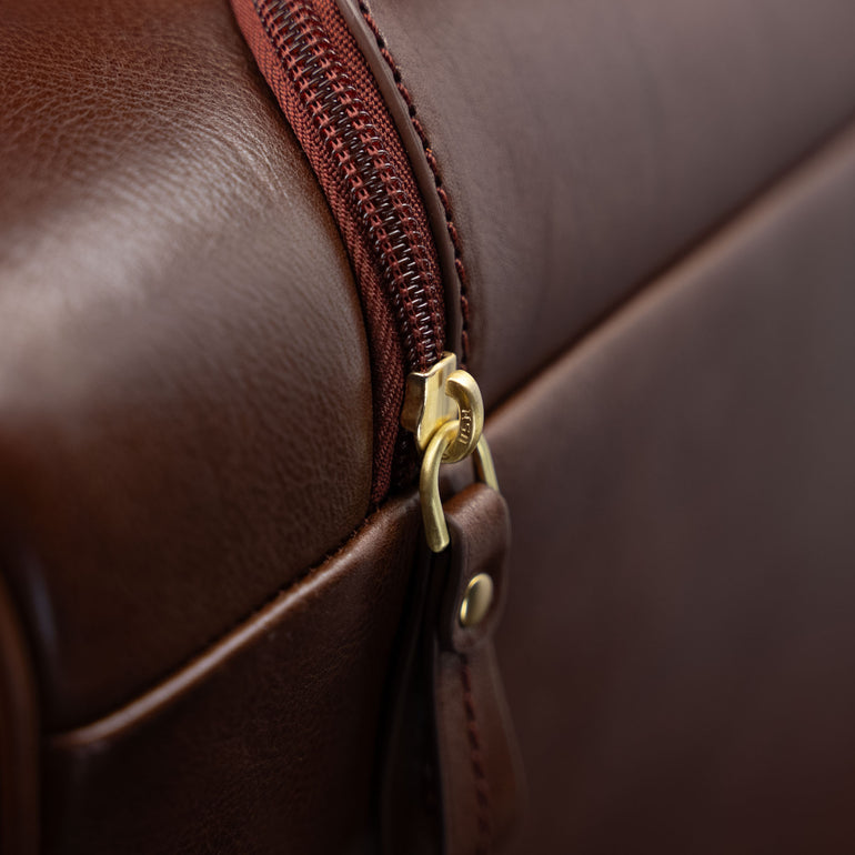 Close-up of the zipped pocket for the handle on the brown Von Baer Voyager women's luxury leather carry on bag