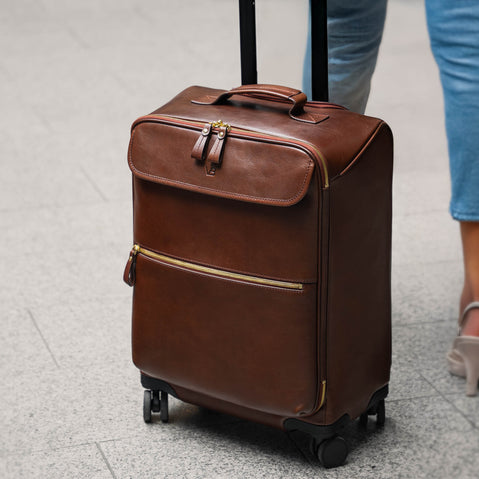 Female model with Von Baer Voyager luxury leather carry on bag at airport