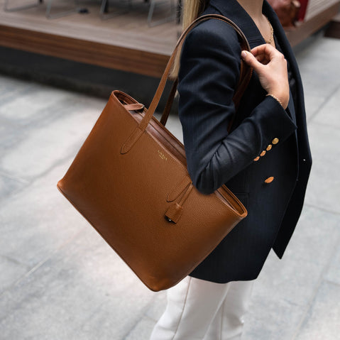 Von Baer Elegance leather tote bag in cognac tan, styled by a female model outdoors