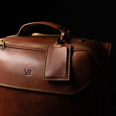 von baer voyager leather carry on travel bag with wheels brown luggage tag close up