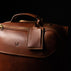 von baer voyager leather carry on travel bag with wheels brown luggage tag close up